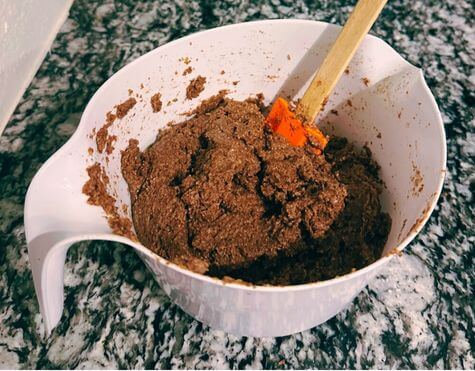Mixing apple cinnamon dough in a bowl with a spatula