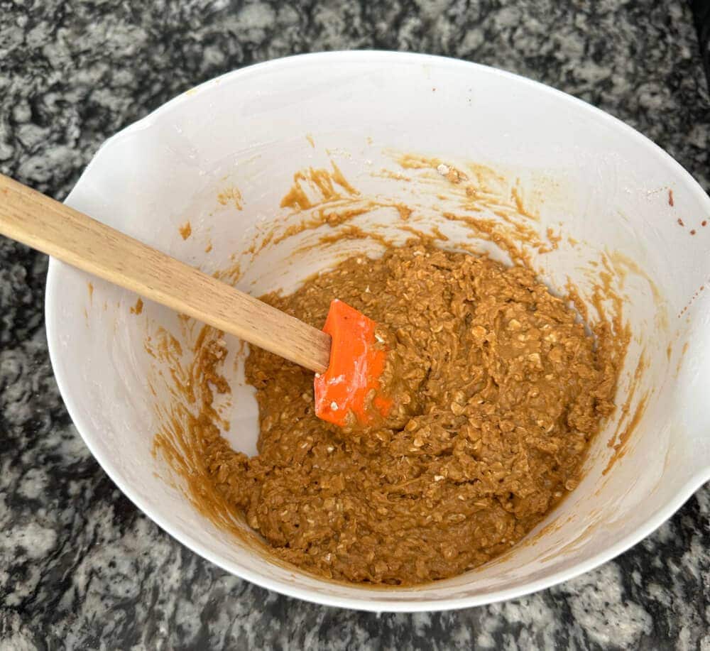 Horse cookie dough mixture in a bowl with a spatula