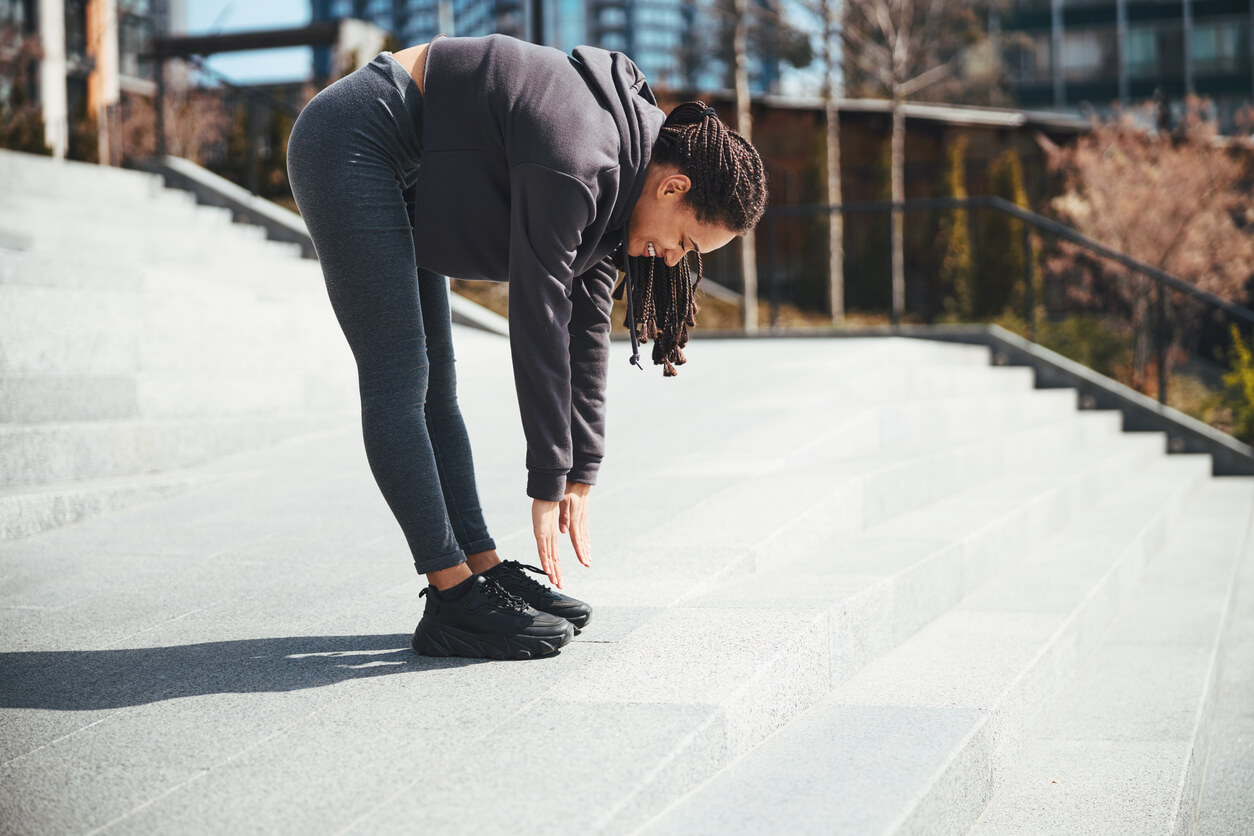 image of woman performing standing hamstring stretch