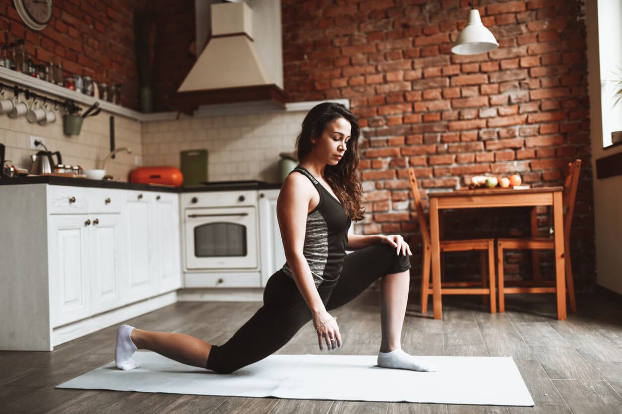 image of woman performing a kneeling lunge stretch