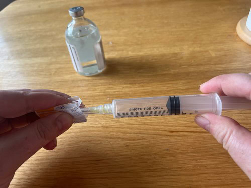 attaching a needle to a syringe